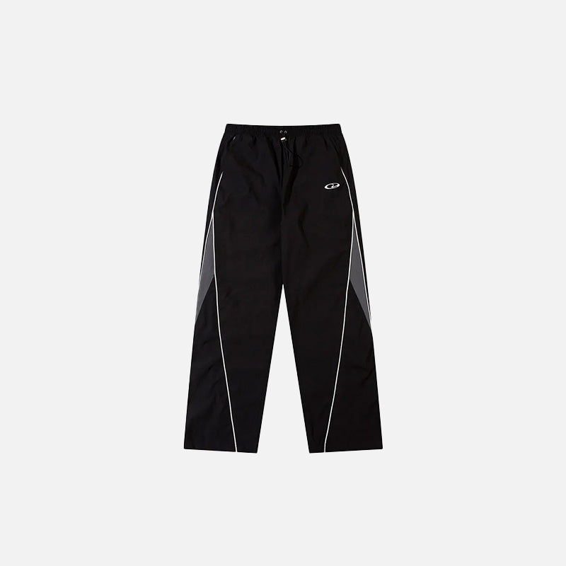 Front view of the Y2K Black Patchwork Sports Pants in a gray background