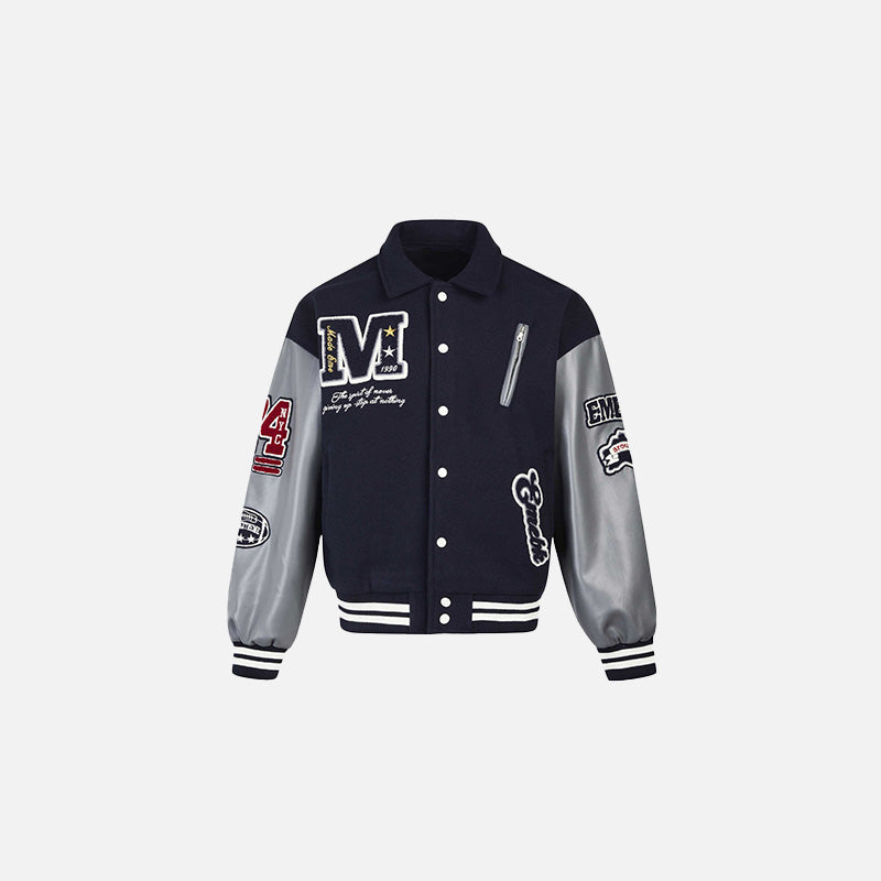 Front view of the navy blue Patchwork Varsity Jacket in a gray background