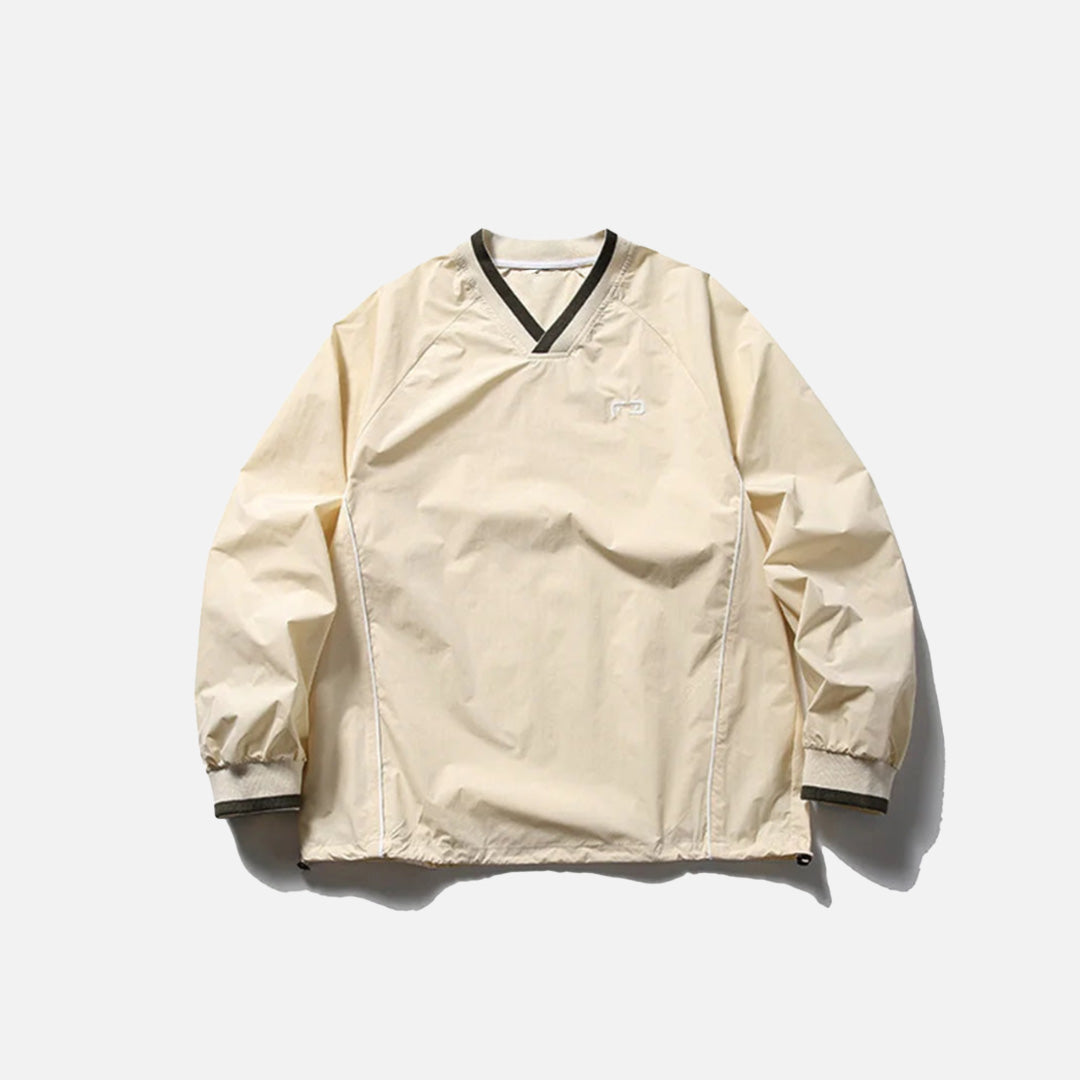 Front view of the beige Metro Breeze Windbreaker Sweatshirt in a gray background
