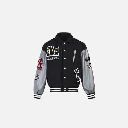 Front view of the black Patchwork Varsity Jacket in a gray background