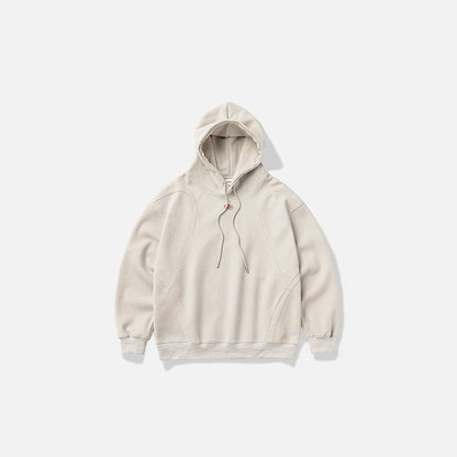 Front view of the beige Zen Mod Hoodie in a gray background